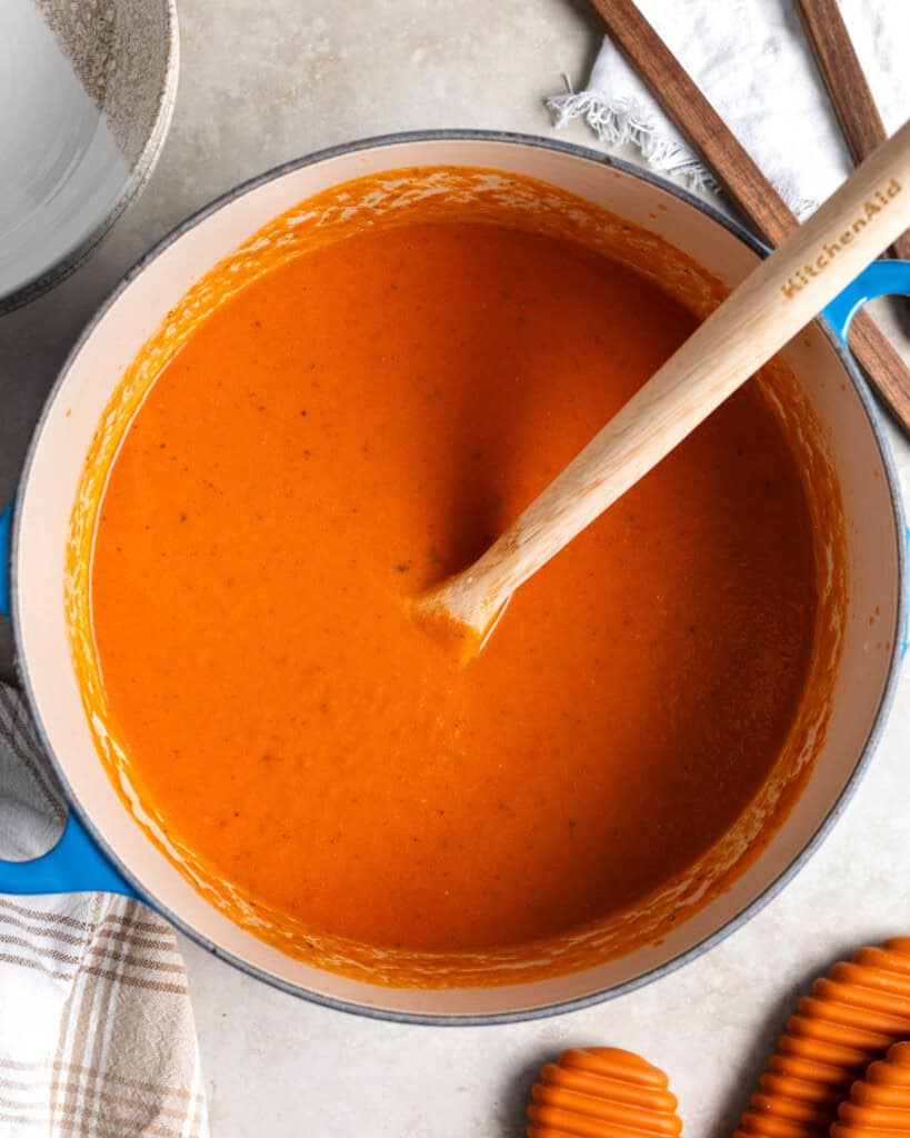 Tomato soup in the pot after blending and stirring in the Parmesan and cream.