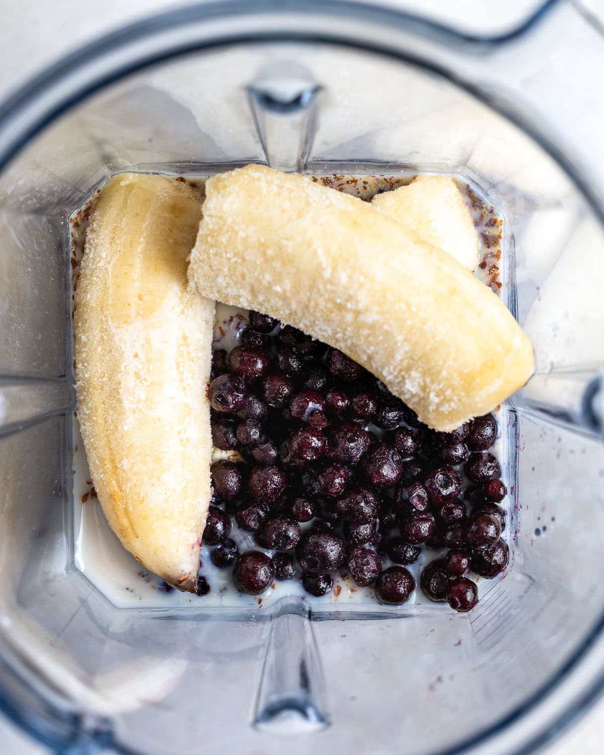 All smoothie ingredients in a blender before blending.