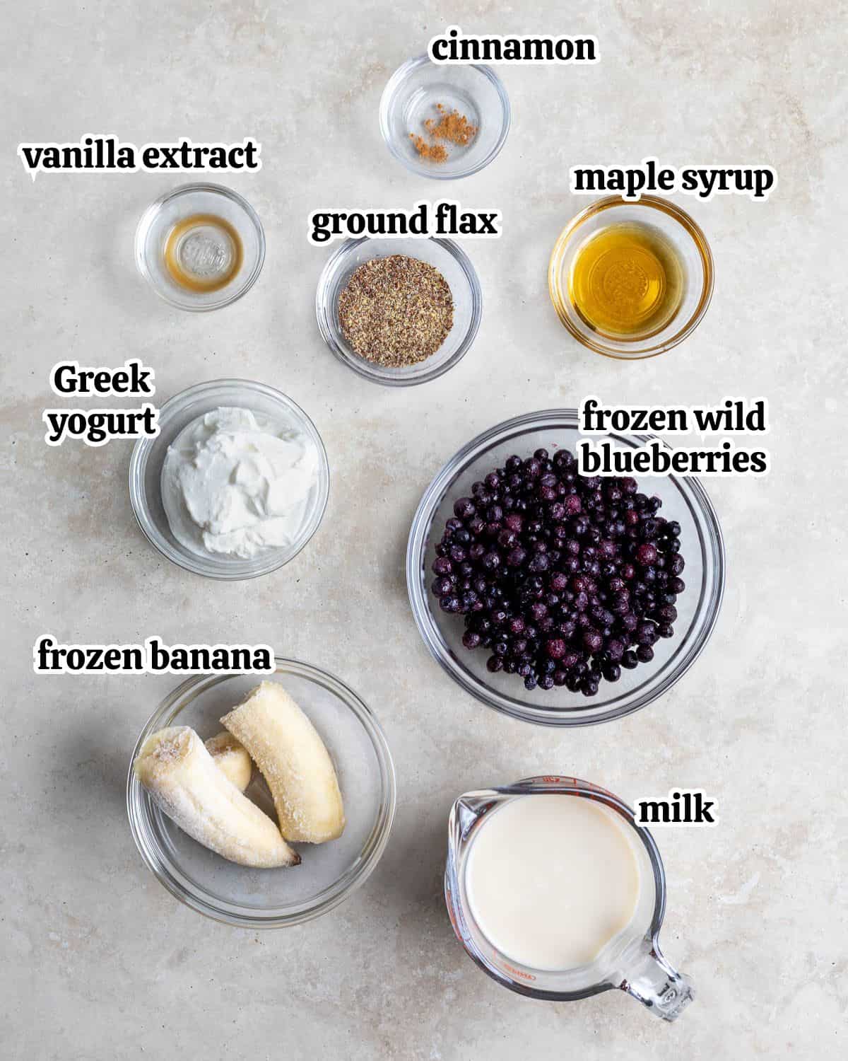 Text-labeled wild blueberry smoothie ingredients in separate containers.