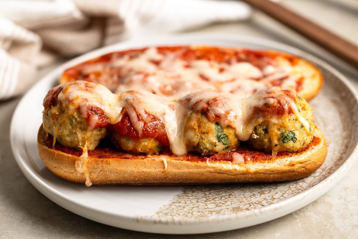 An open-face meatball sub with Italian baked turkey meatballs, marinara sauce, and melted cheese.