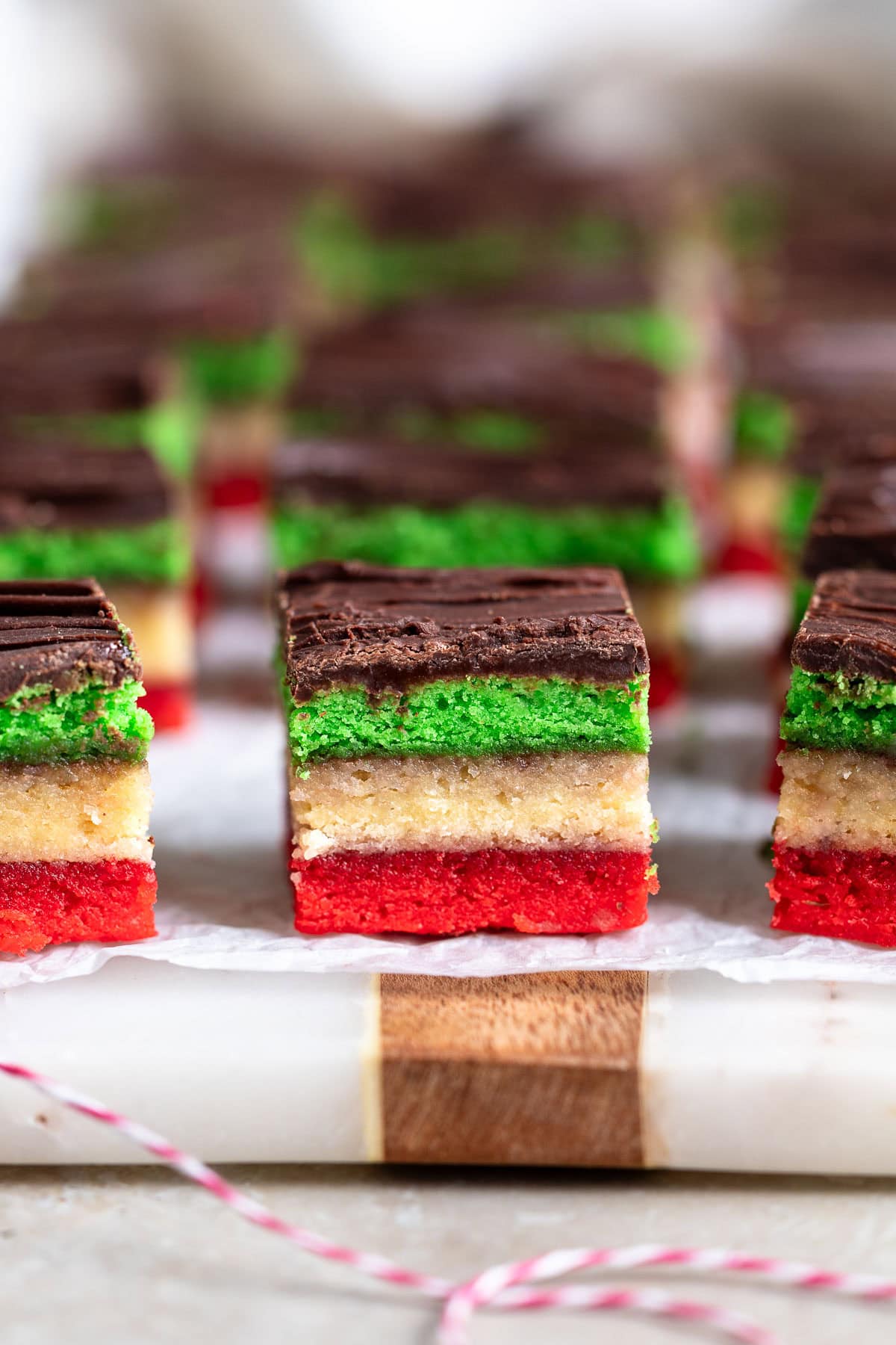 Sliced Italian rainbow cookies on a board.