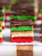 Sliced Italian rainbow cookies on a board.
