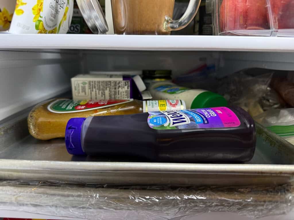 Fridge items weighing down a slab of Italian rainbow cookies overnight.