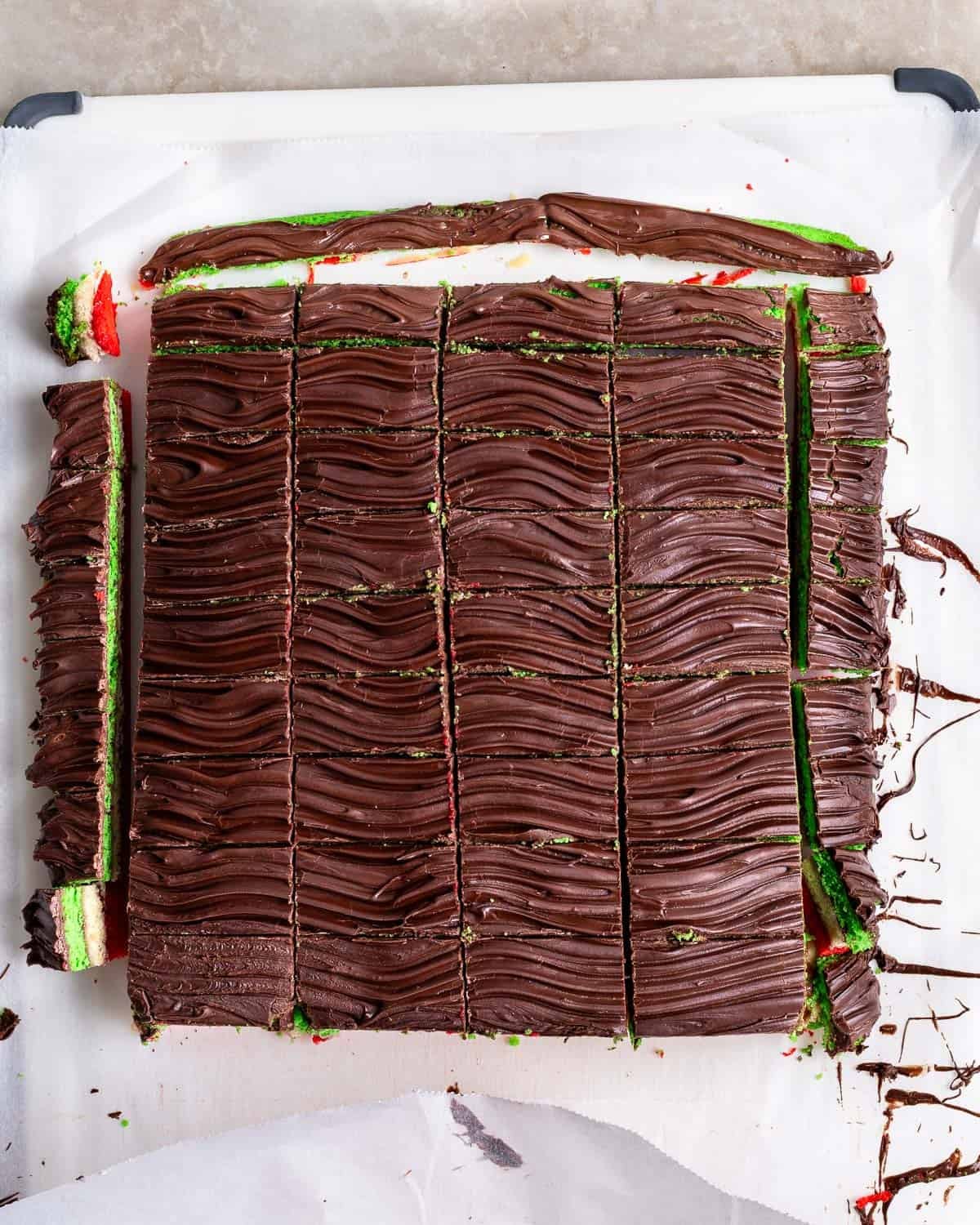The slab of rainbow cookies cut into slices.